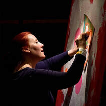 Kate Green painting at a conference 